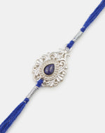 Blue Metal Tear Drop Motif Rakhi With Blue Stone