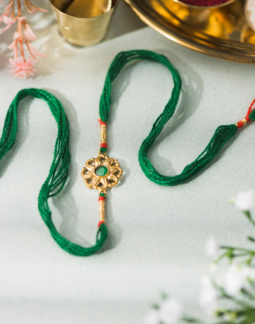 Green Metal Gold Tone Traditional Floral Design With Green Stone Rakhi